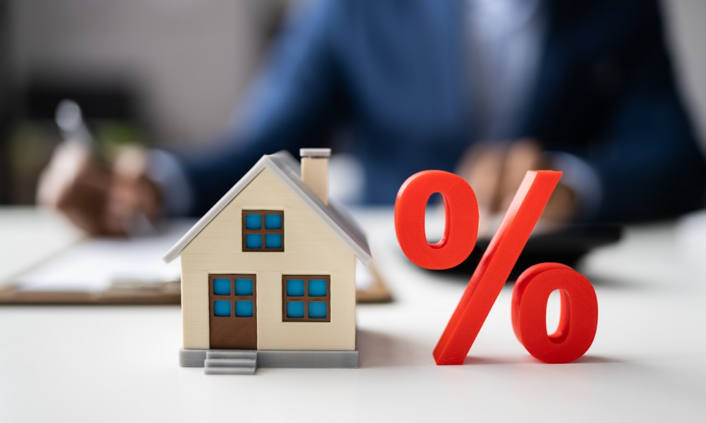Model house beside a percentage symbol representing mortgage interest. Model house beside a percentage symbol representing mortgage interest.